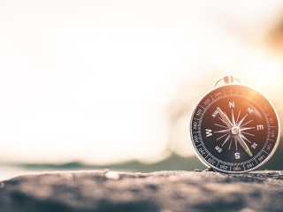 Compass resting on a rock